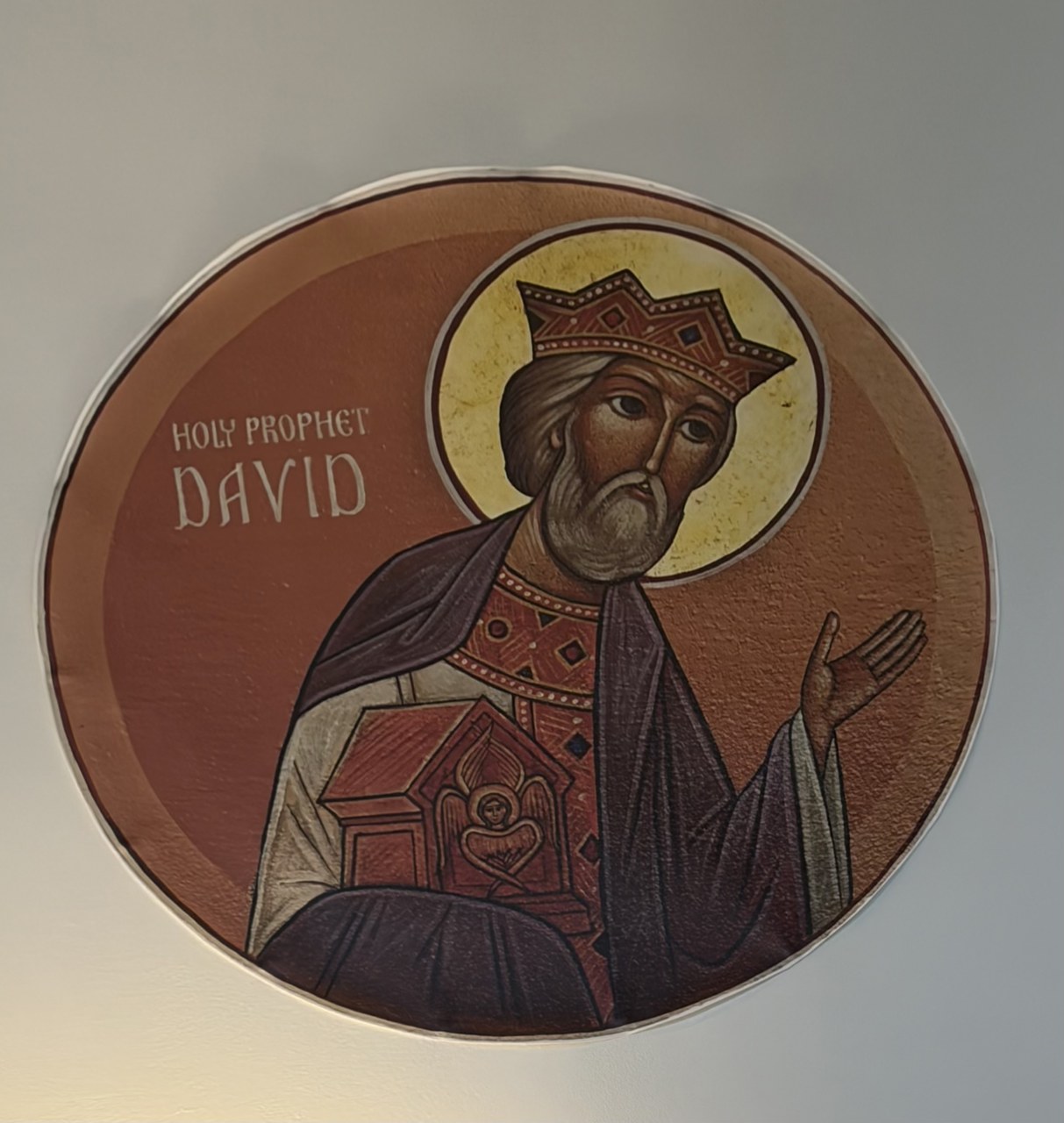 Church icon of the crowned prophet David holding a small tabernacle, painted in burgundy and gold.
